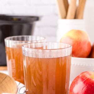 slow cooker apple cider in beautifully adorned glasses.