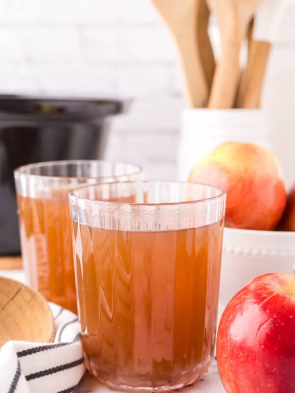 slow cooker apple cider in beautifully adorned glasses.