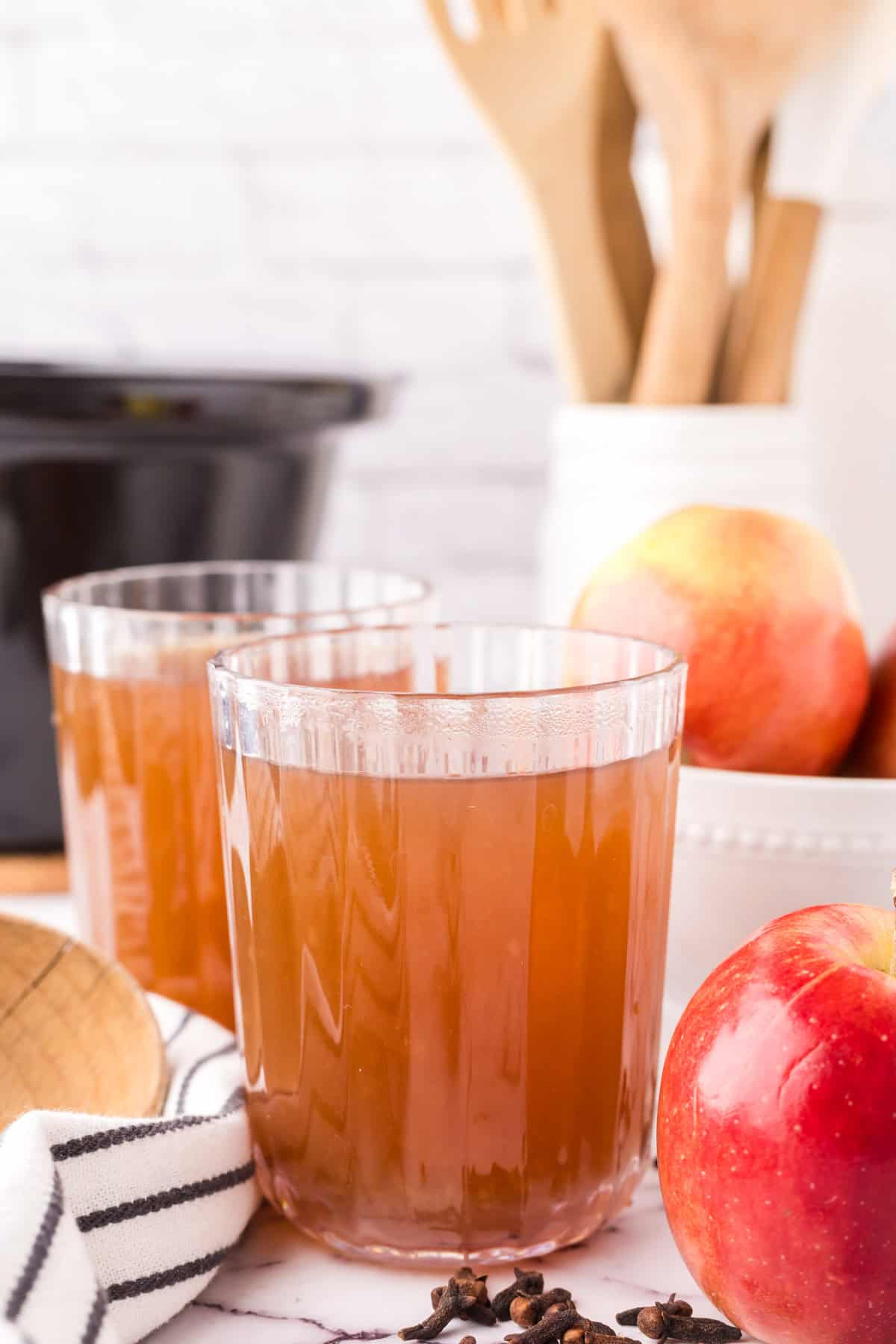 slow cooker apple cider in beautifully adorned glasses.