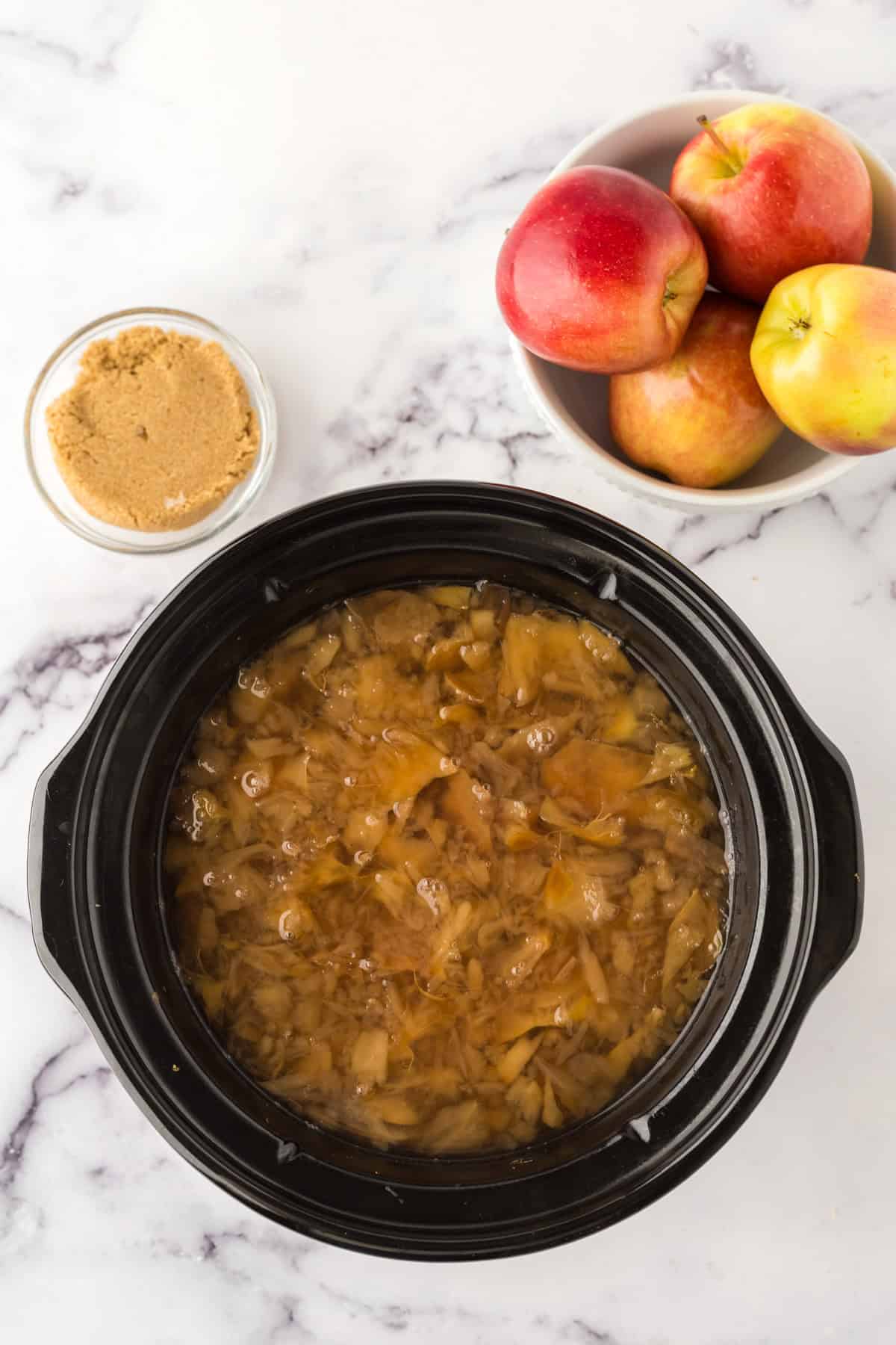 slow cooker apple cider in the pot.