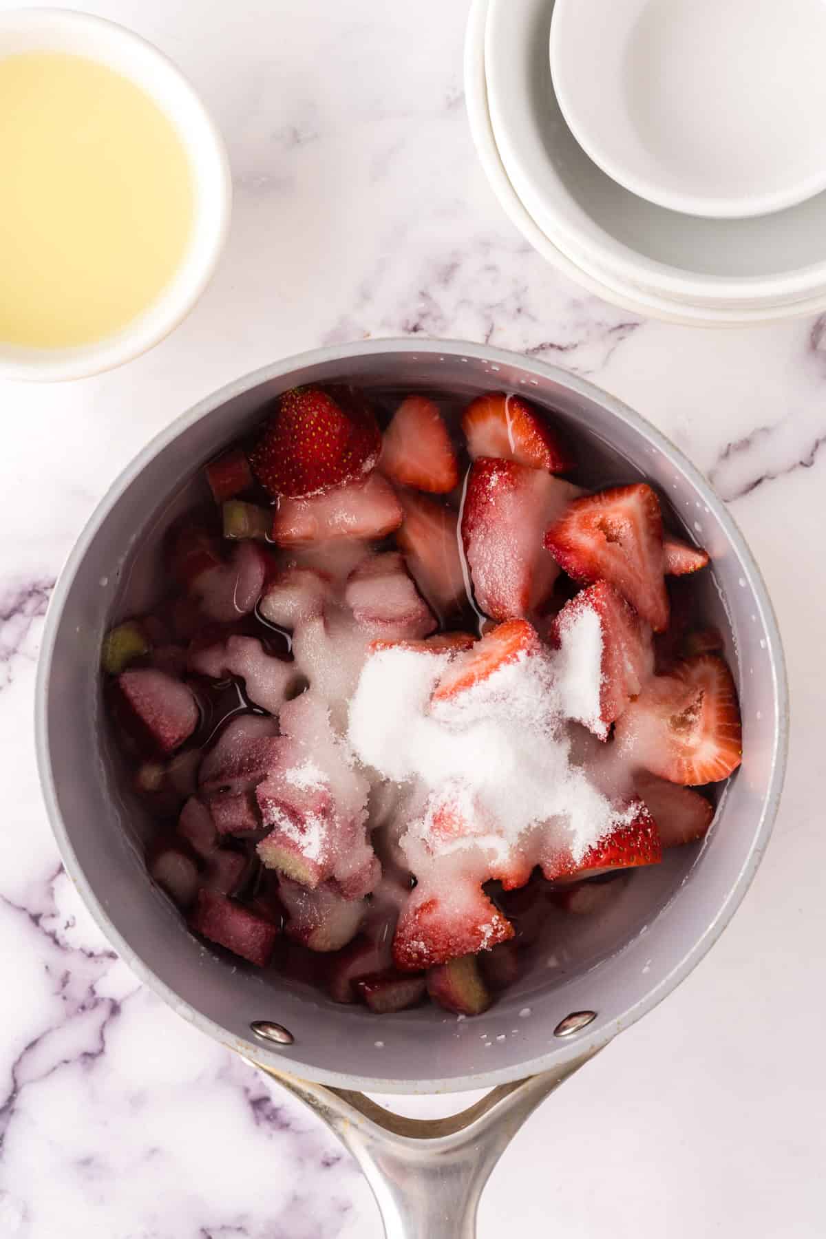 sauce pan reducing down the ingredients to make strawberry rhubarb lemonade.