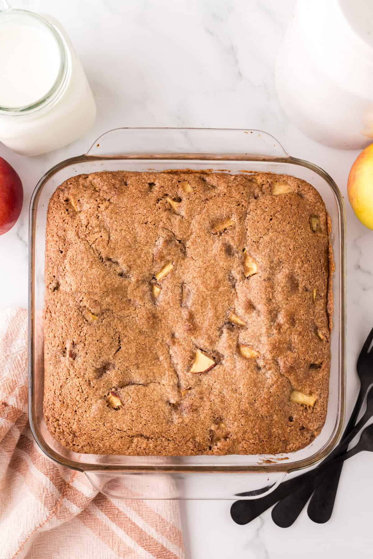 whole apple cake recipe in a glass pan.