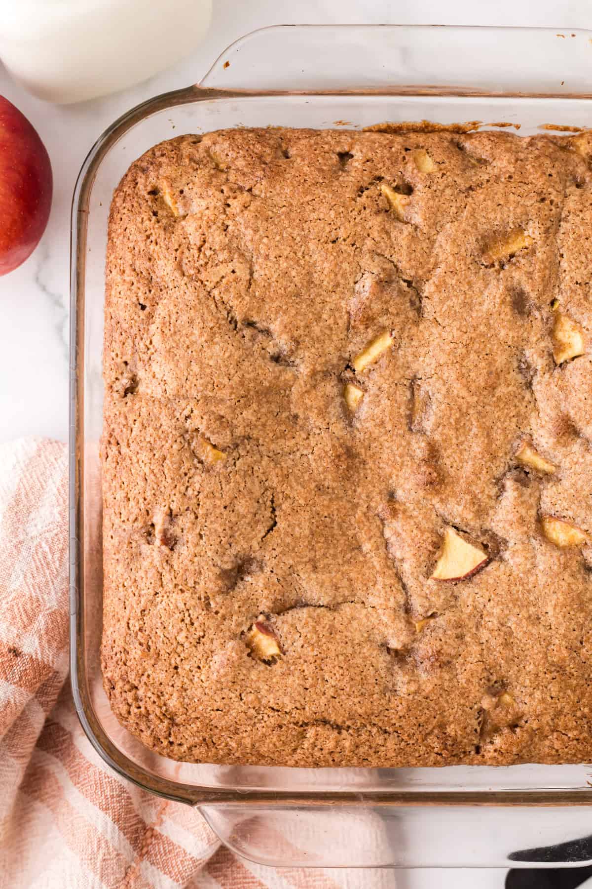 whole apple cake recipe in a glass pan.