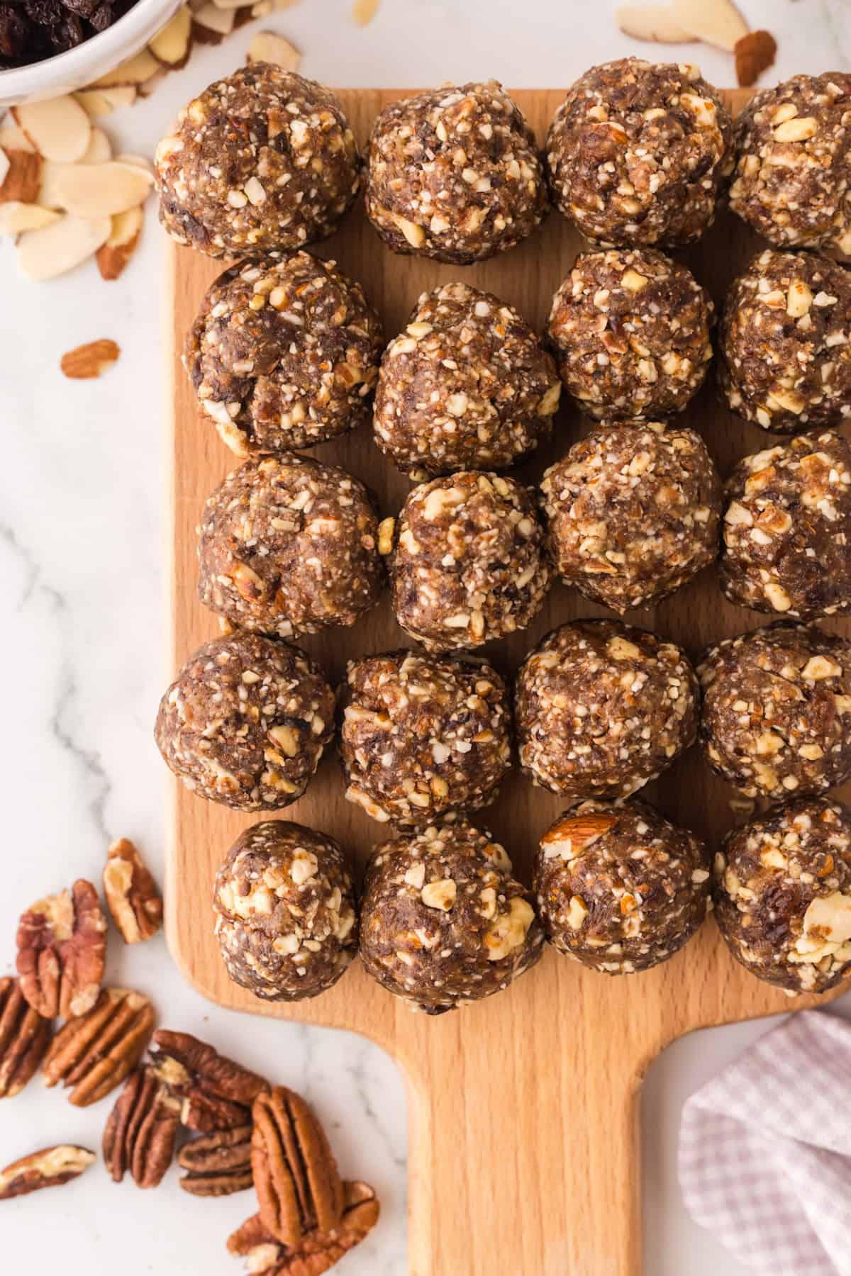 cherry energy balls on a wooden board.