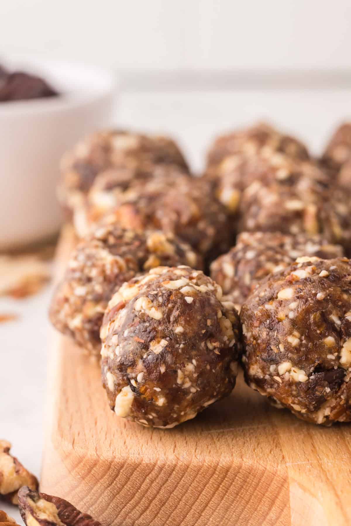 cherry energy balls on a wooden board.