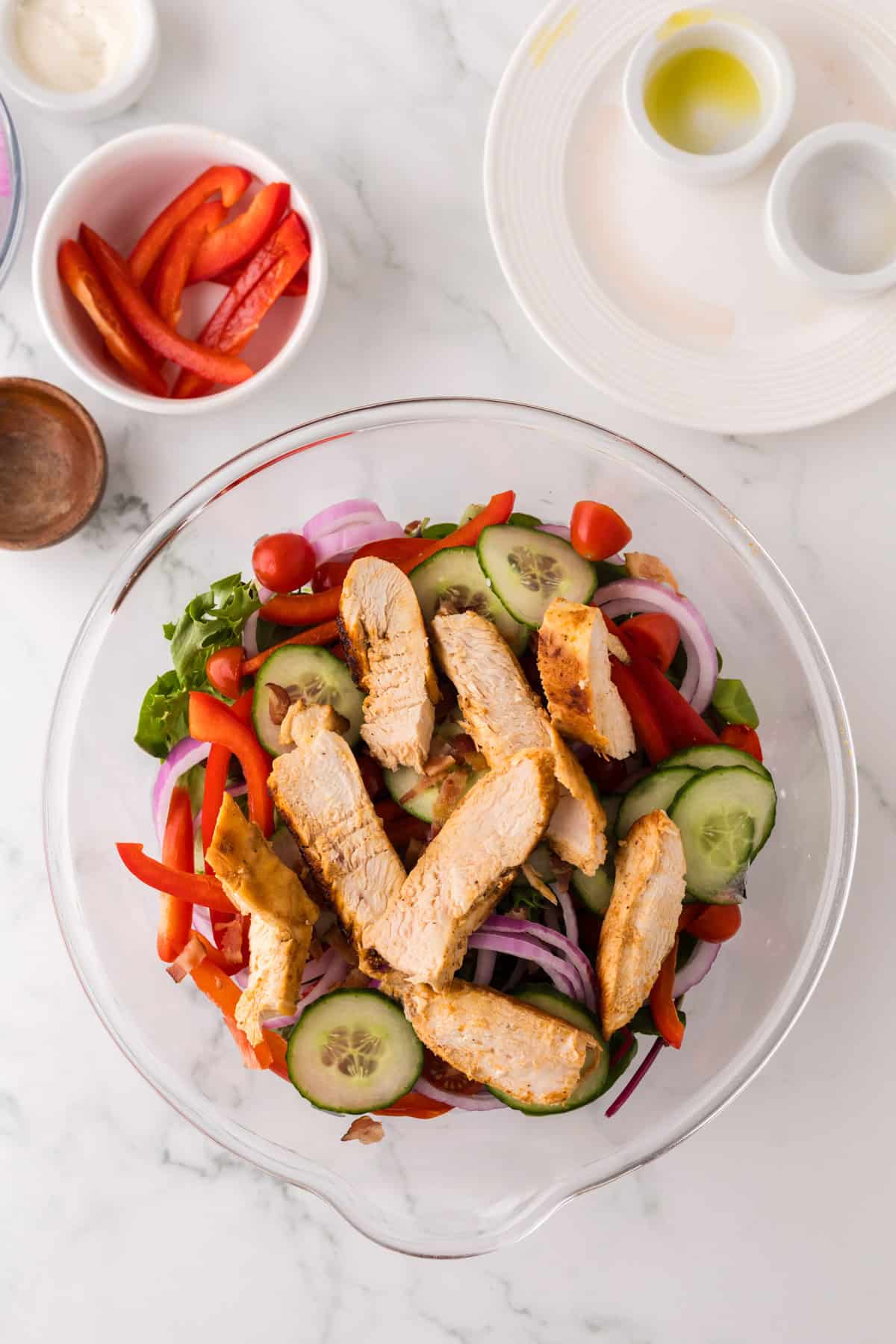 chicken bacon ranch salad ingredients in a clear mixing bowl.