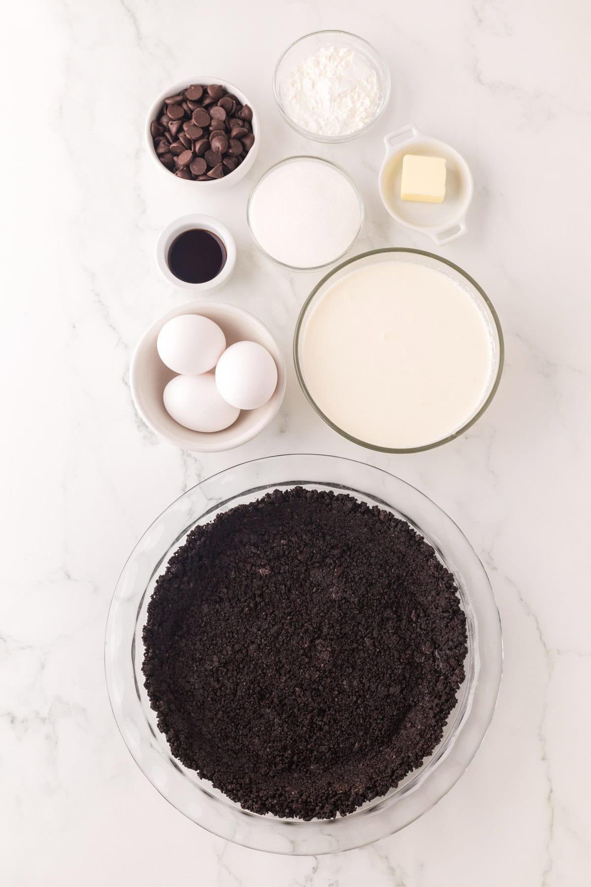 portion bowls each with raw ingredients to make chocolate cream pie recipe.