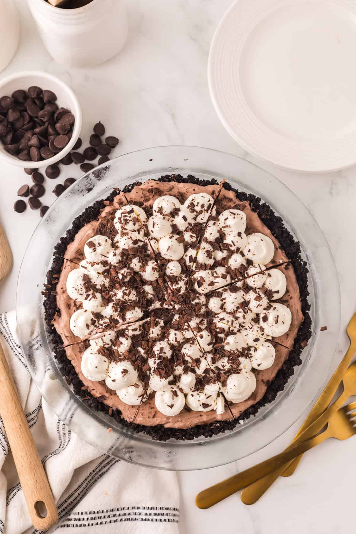 whole chocolate cream pie recipe with dollops of cream and chocolate on top.