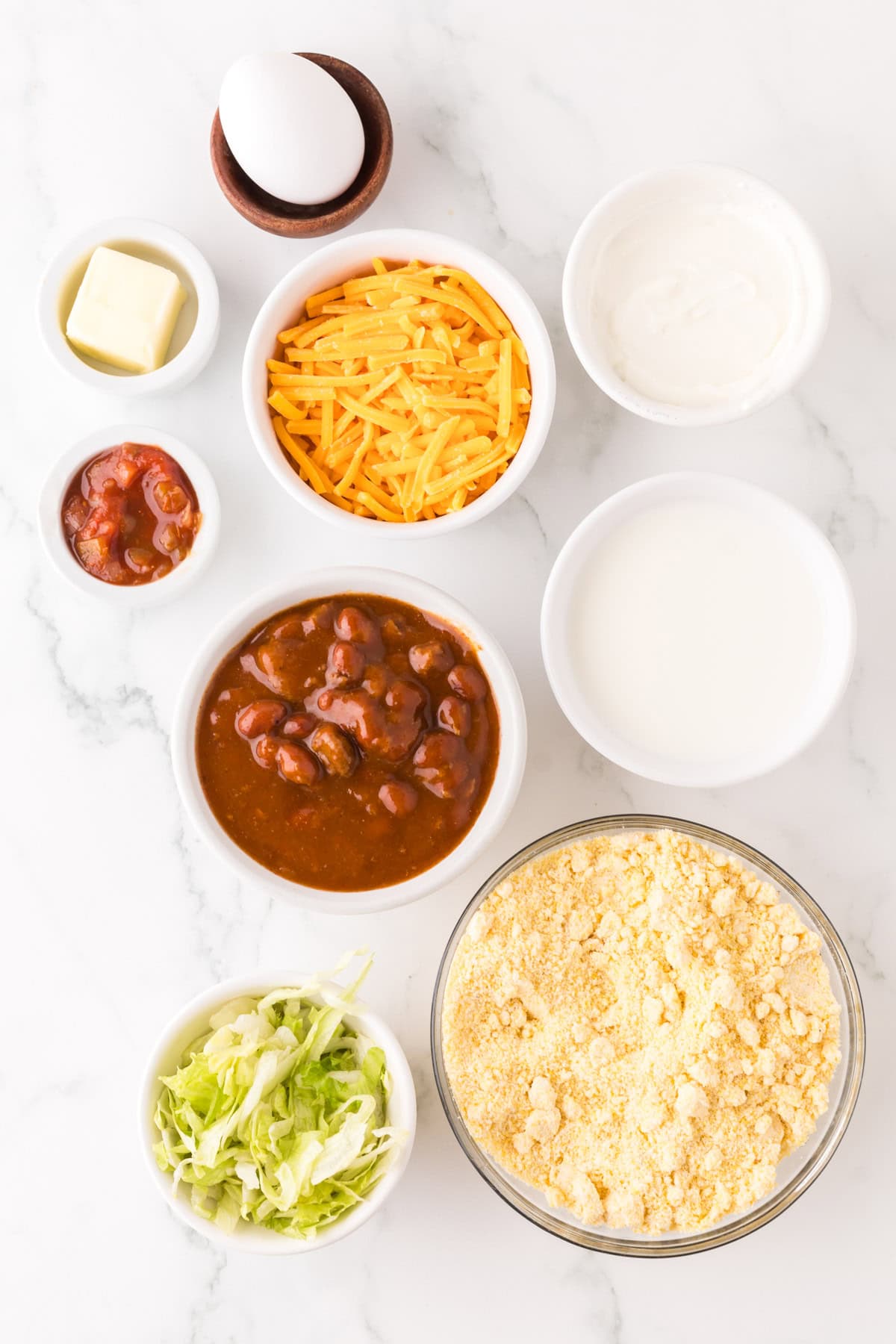 portion bowls each with raw ingredients to make cornbread waffles with chili recipe.