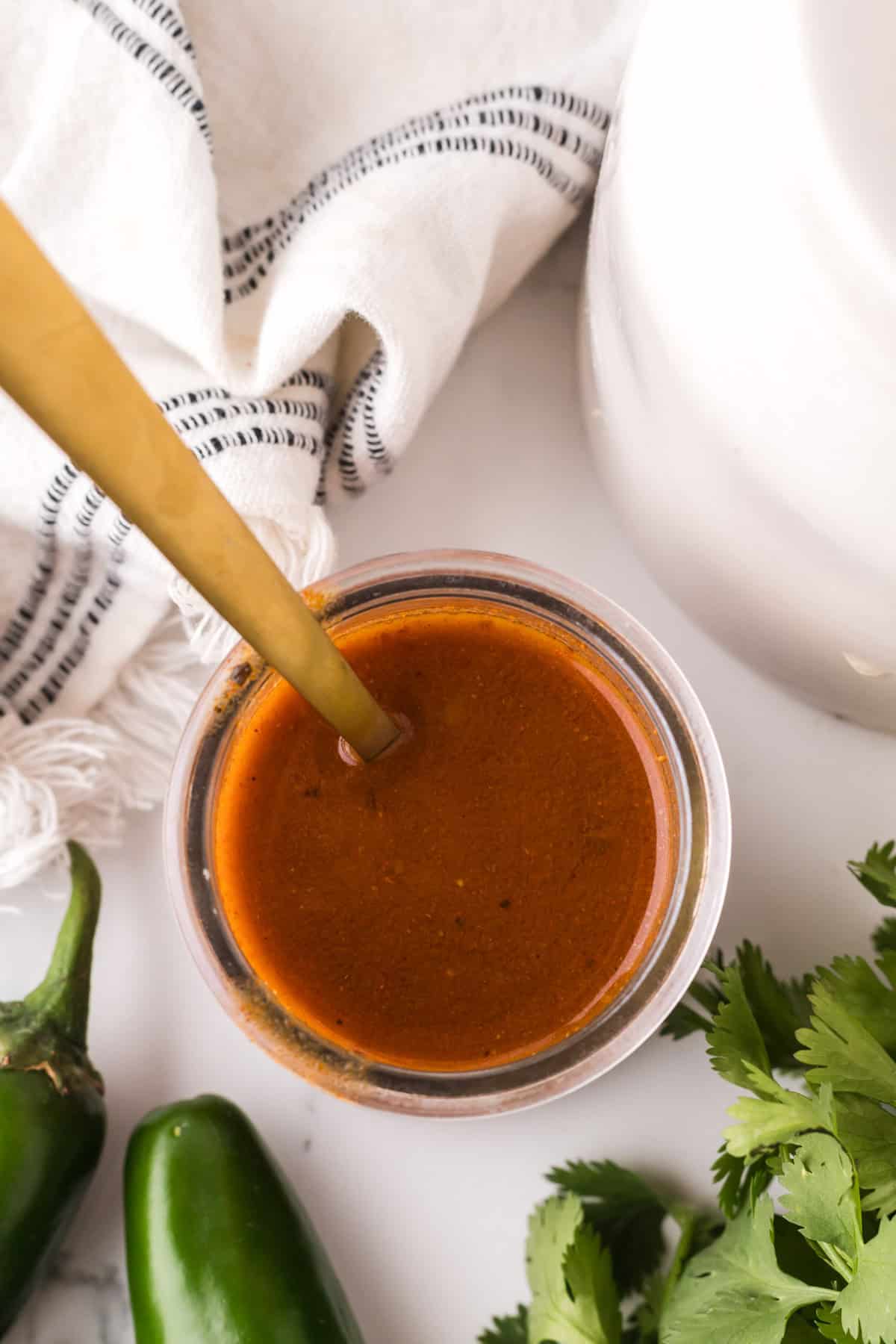 red enchilada sauce in a glass dish.