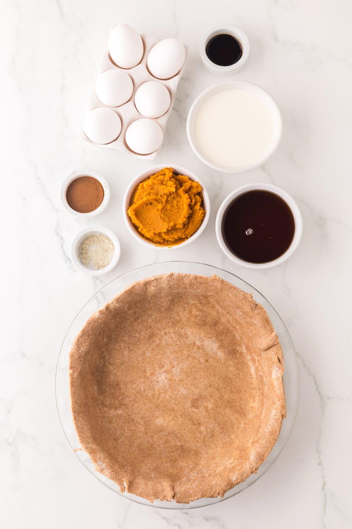 portion bowls each with raw ingredients to make healthy pumpkin pie recipe.