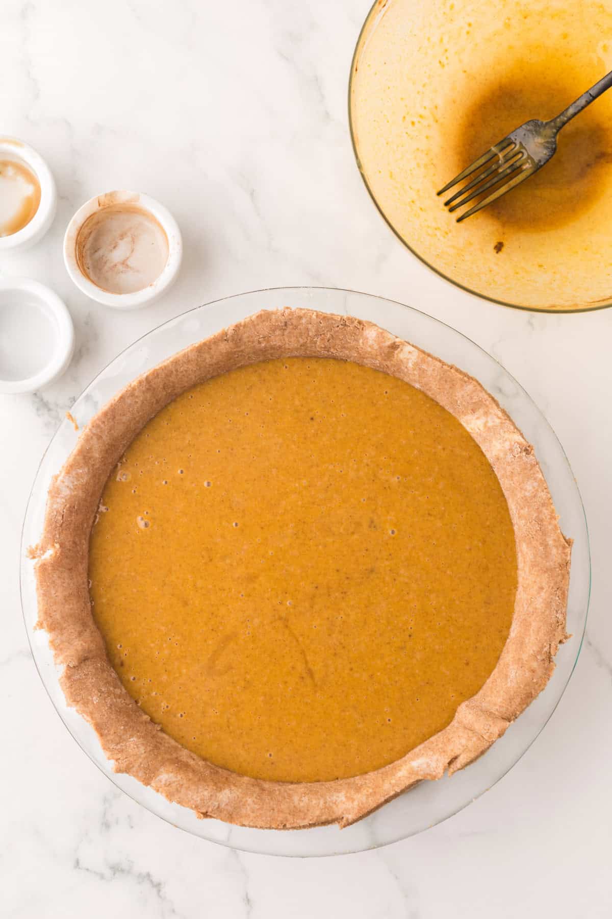 clear mixing bowl in the process of making healthy pumpkin pie recipe.