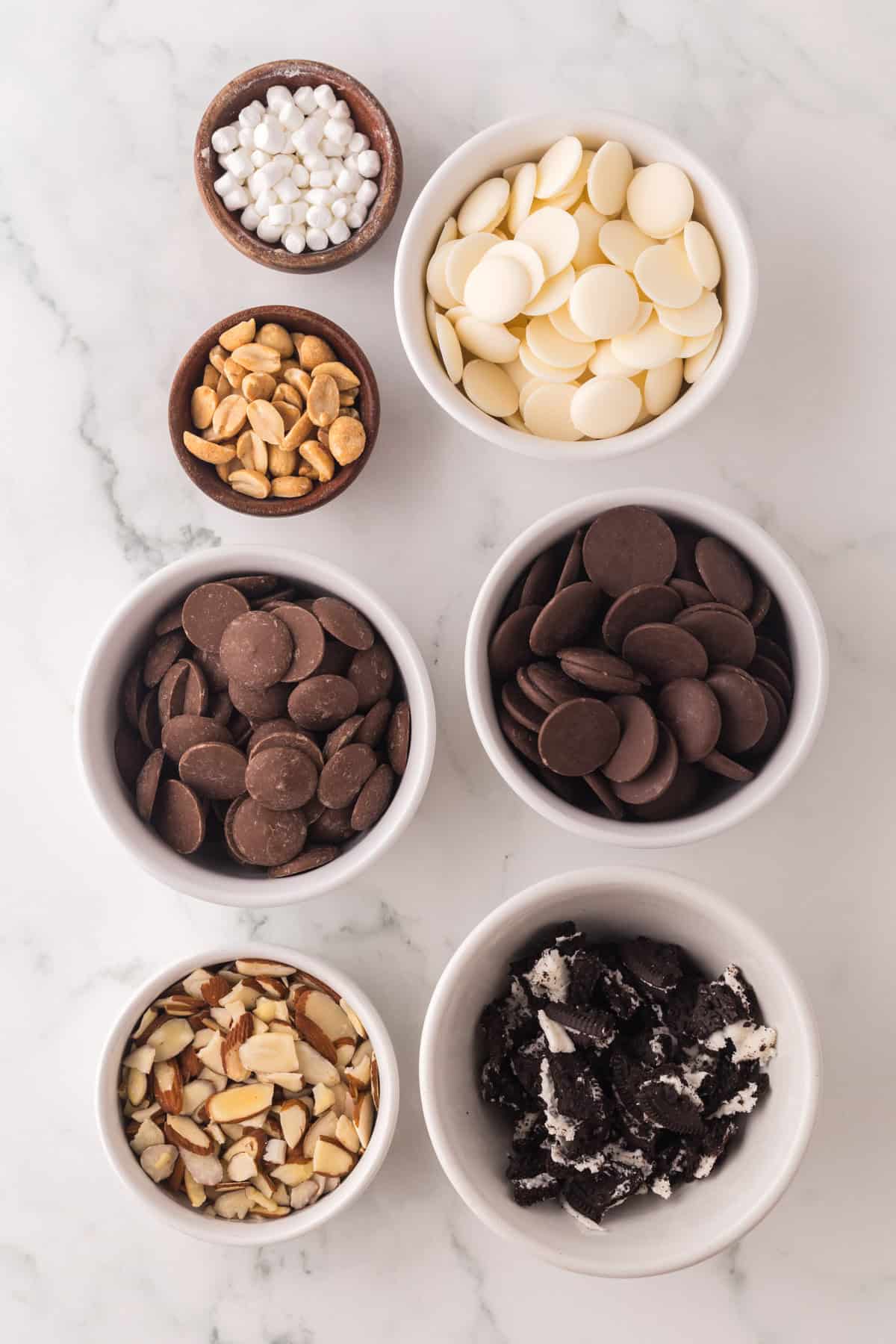 portion bowls each with raw ingredients to make homemade candy bars.