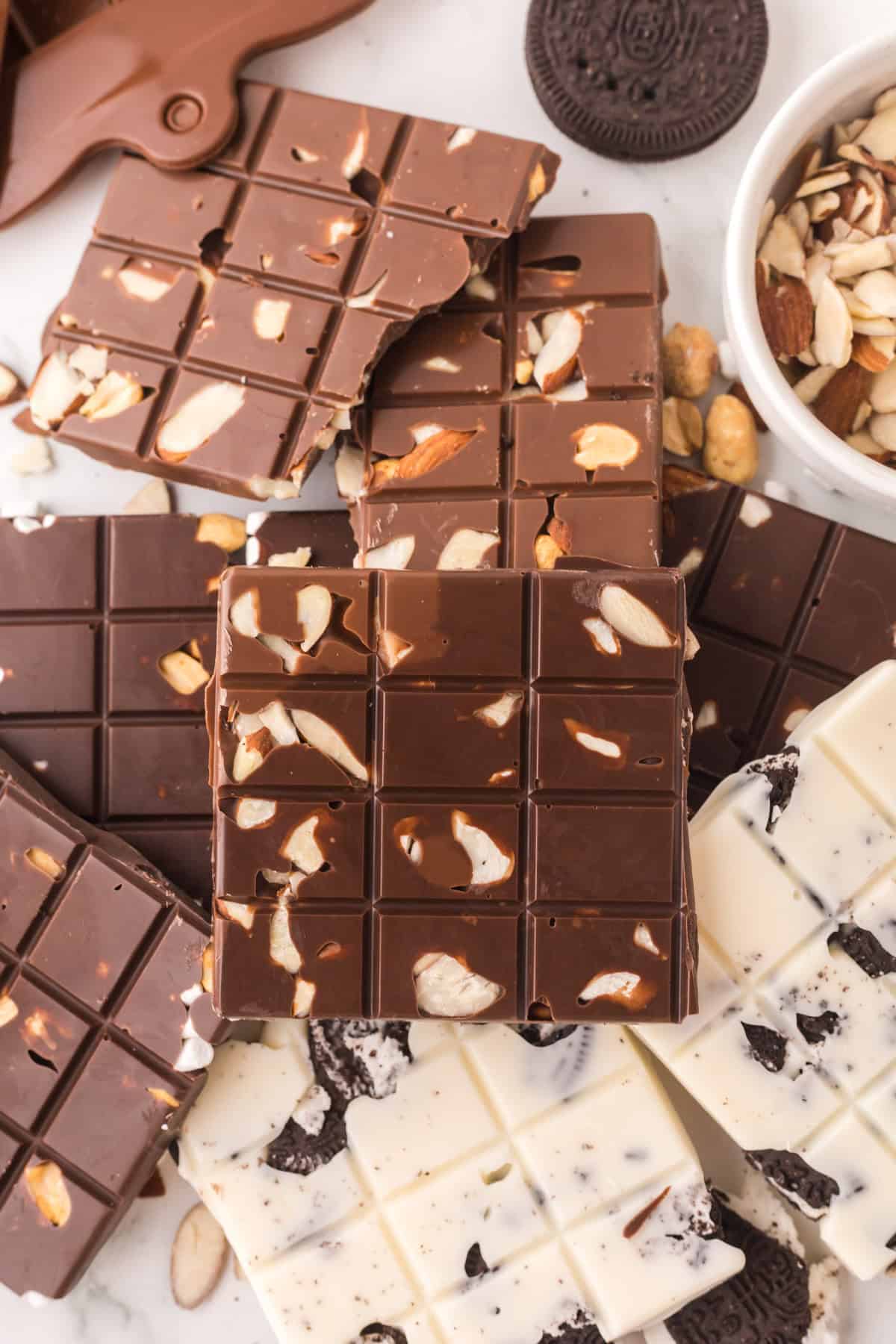 homemade candy bars with white chocolate and milk chocolate with nuts and oreo cookies.