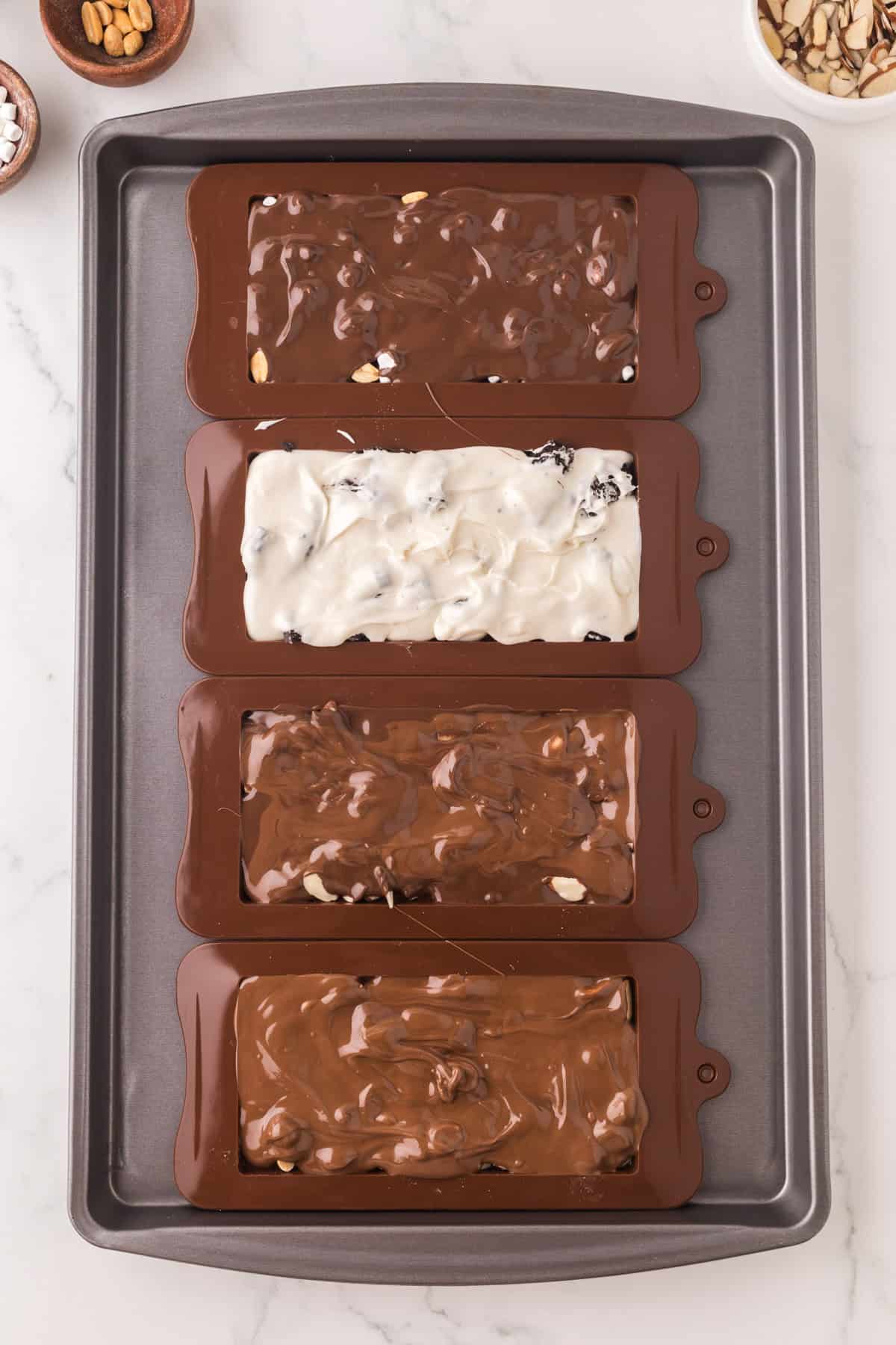 melted chocolate in molds to make homemade candy bars.