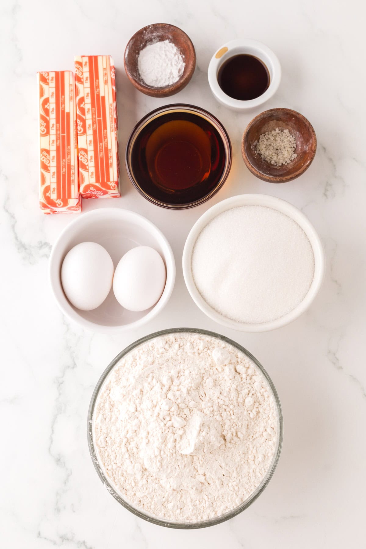 portion bowls each with raw ingredients to make maple sugar cookies.