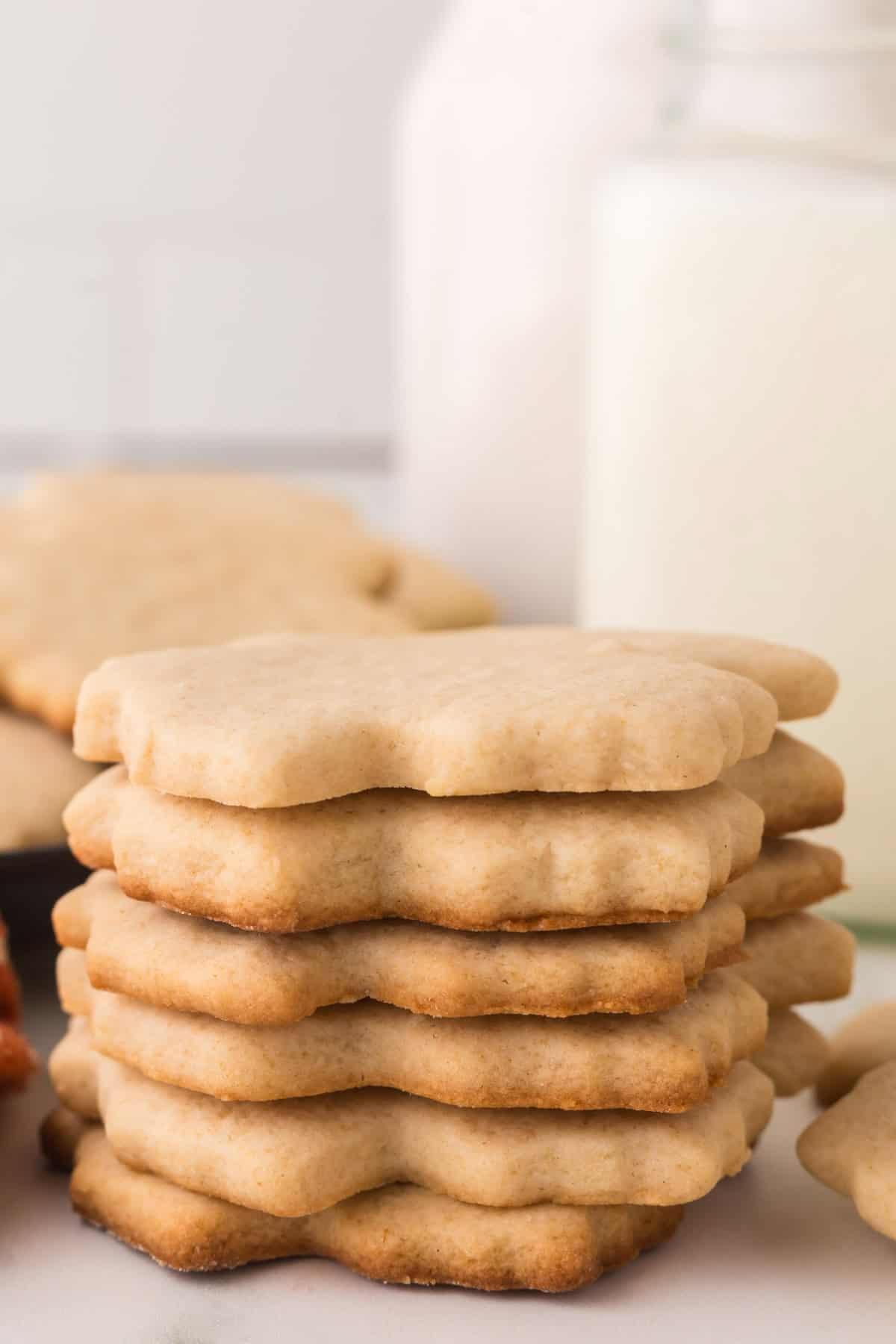 maple leaf shaped maple sugar cookies in a stack.