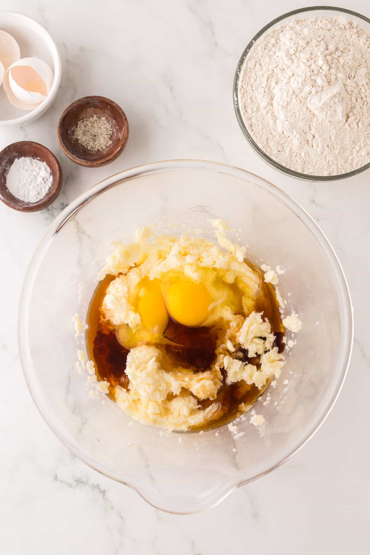 clear mixing bowl in the process of making maple sugar cookies.