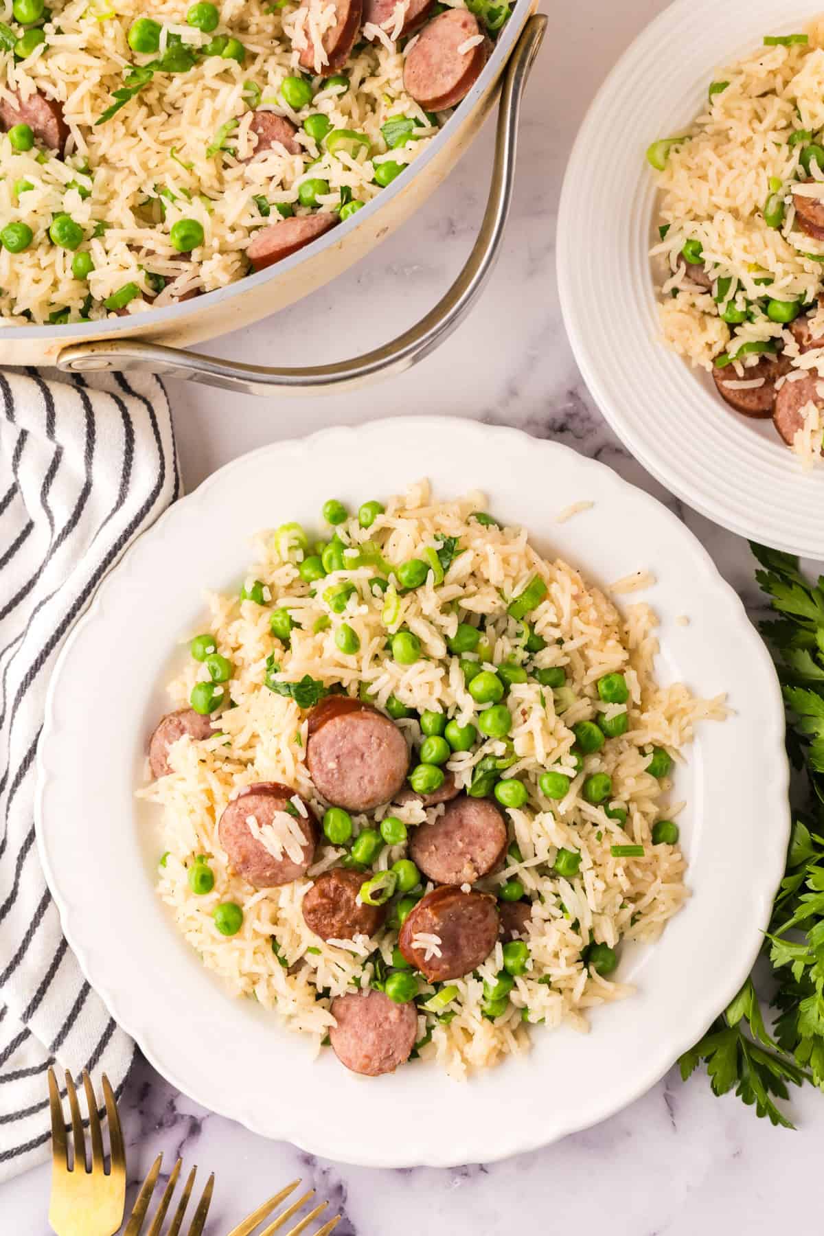 one pot sausage peas and rice recipe on a round white plate.