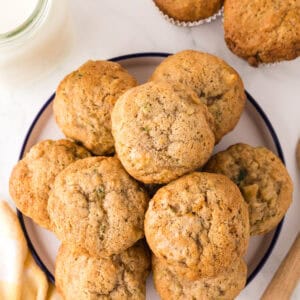 pineapple zucchini muffins in a round stack on a round plate.