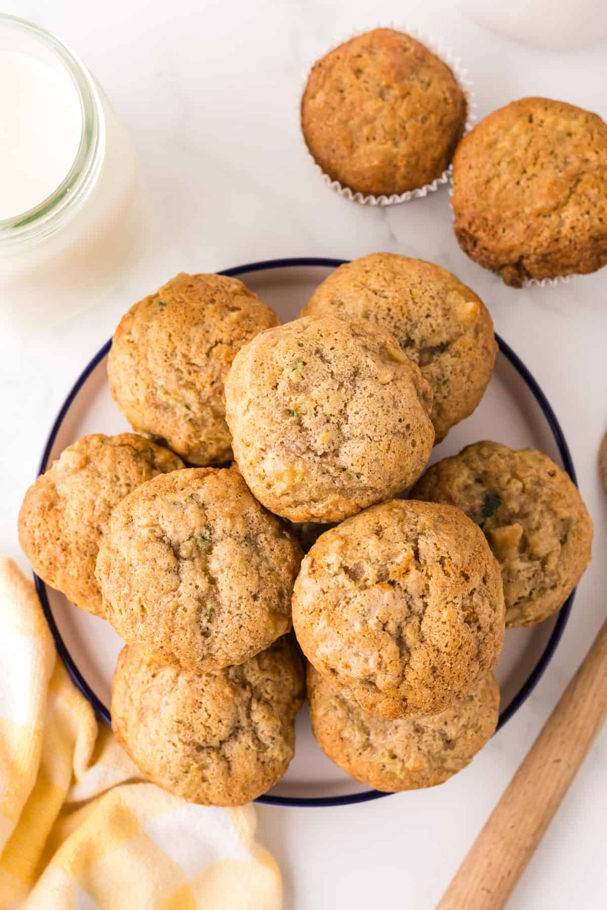 pineapple zucchini muffins in a round stack on a round plate.