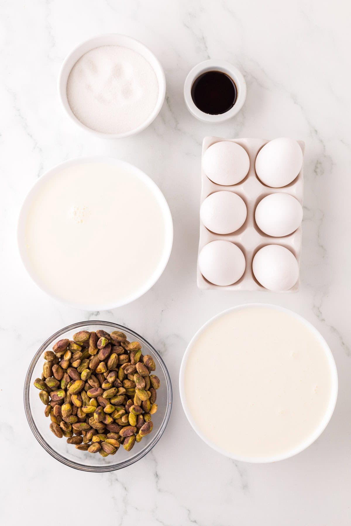 portion bowls each with raw ingredients to make pistachio gelato.