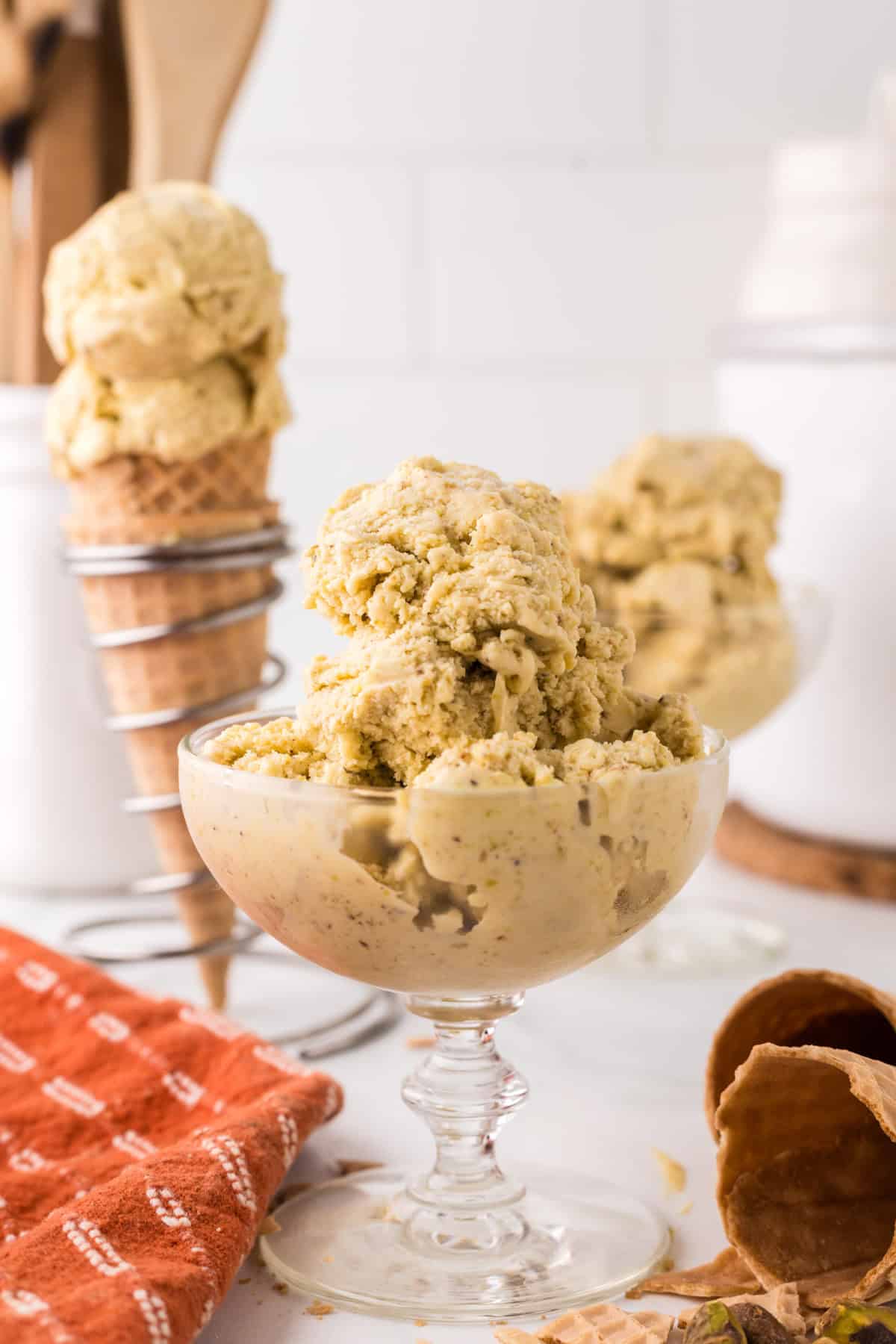 pistachio gelato in a steamed fancy glass dish.