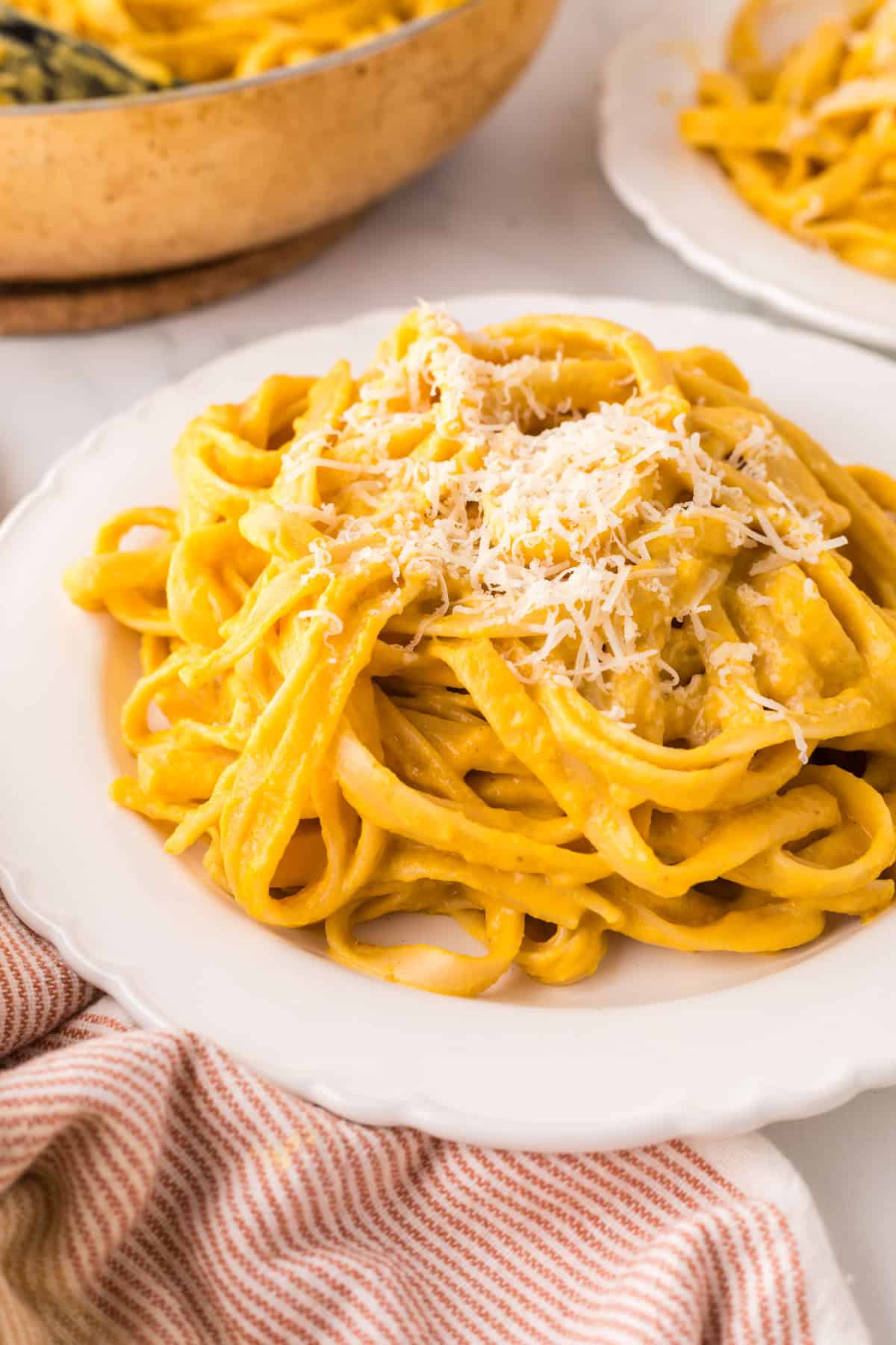 pumpkin Alfredo recipe on a white plate.