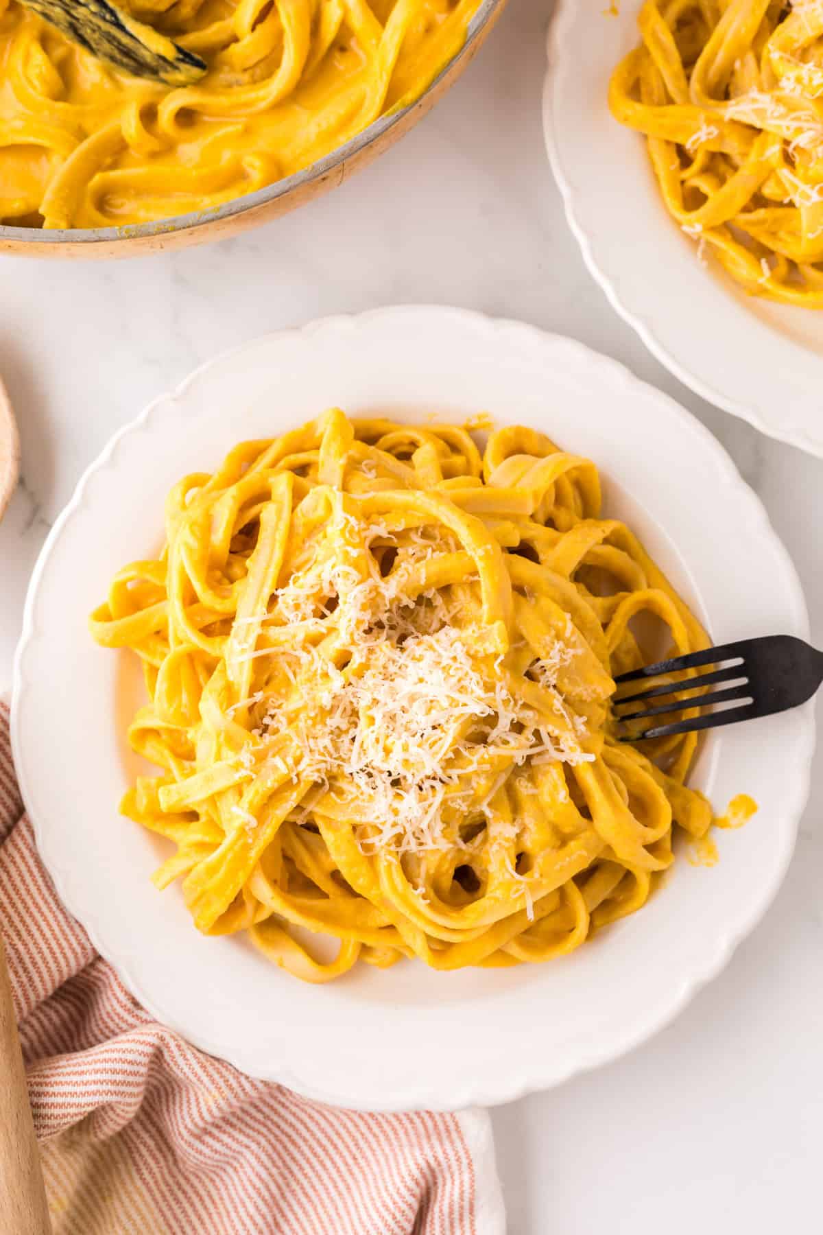 pumpkin Alfredo recipe on a white plate.