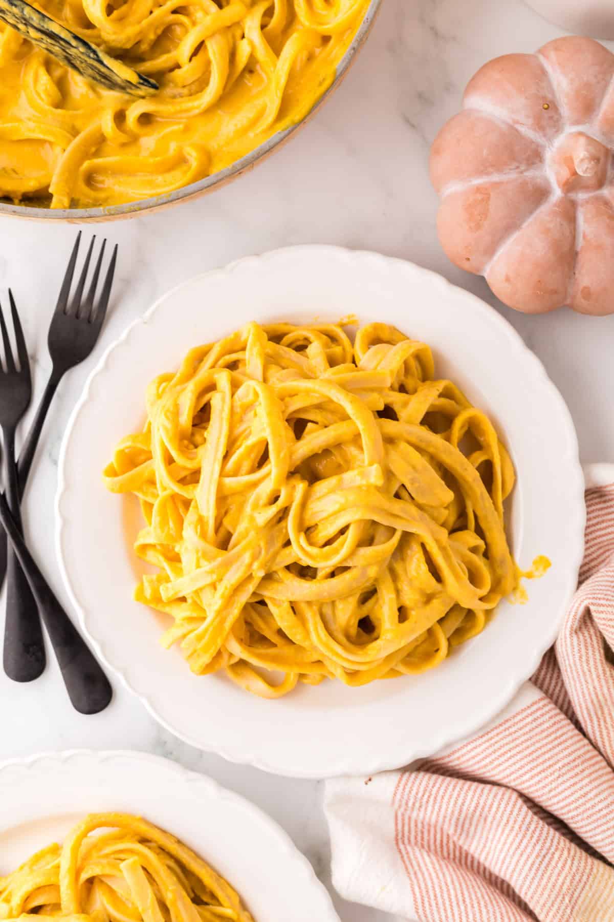 pumpkin Alfredo recipe on a round white plate.