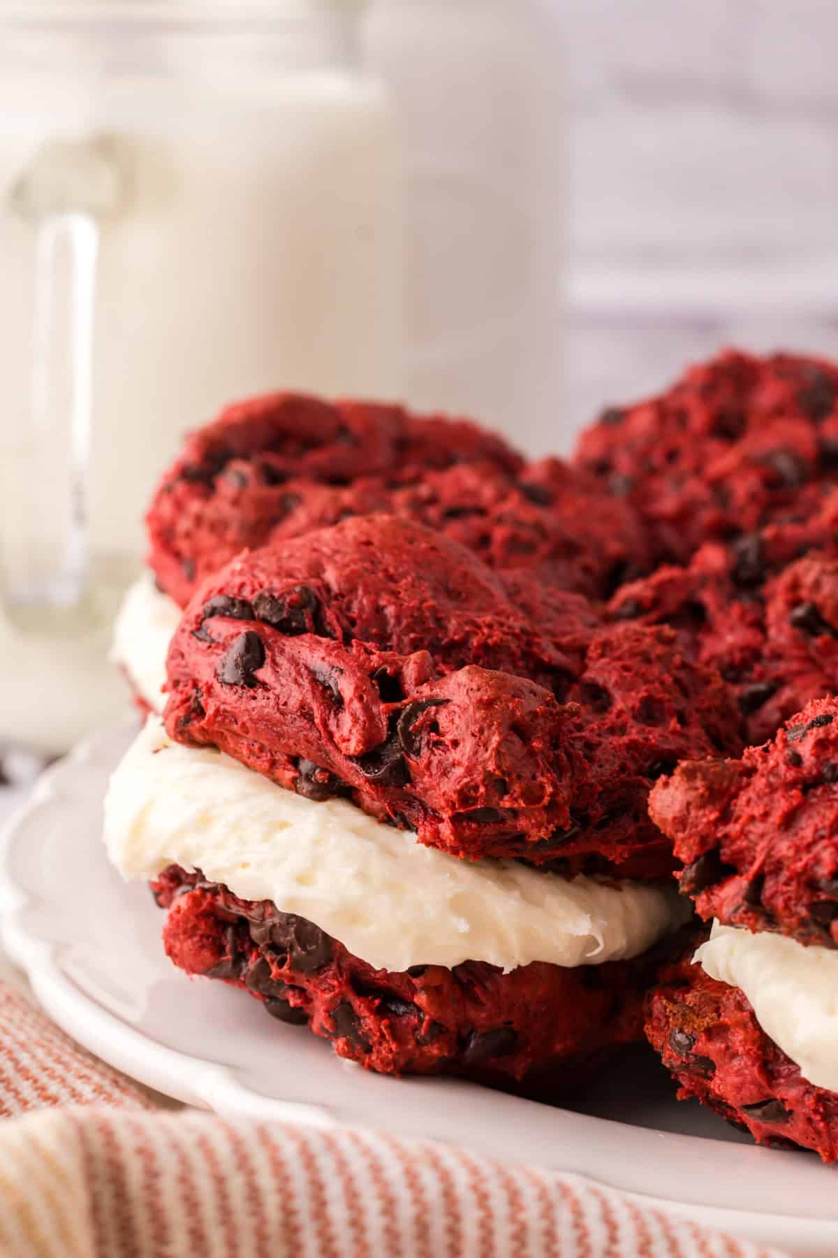 red velvet whoopee pies in a circle on a round white plate.