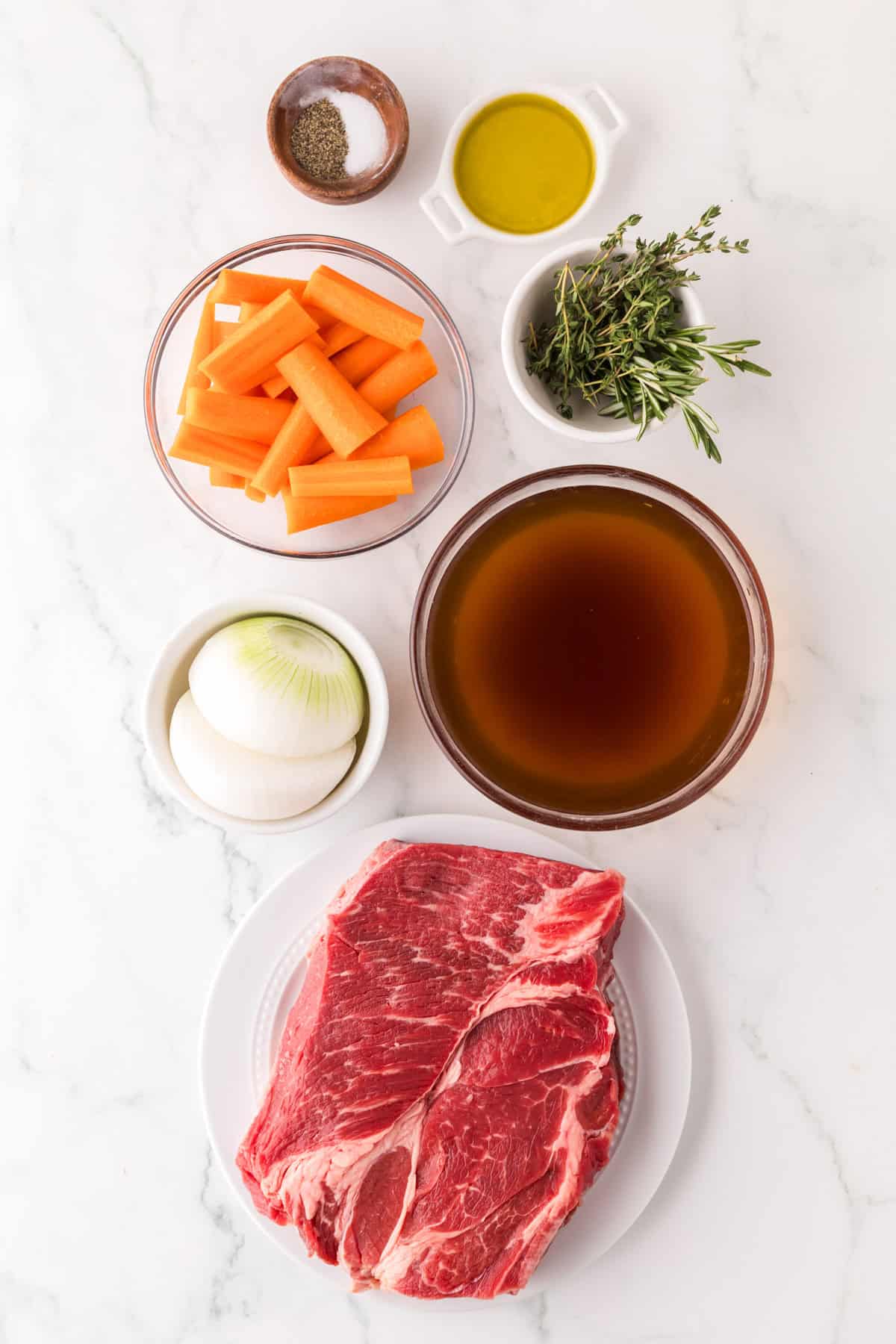 portion bowls each with raw ingredients to make slow cooker pot roast recipe.