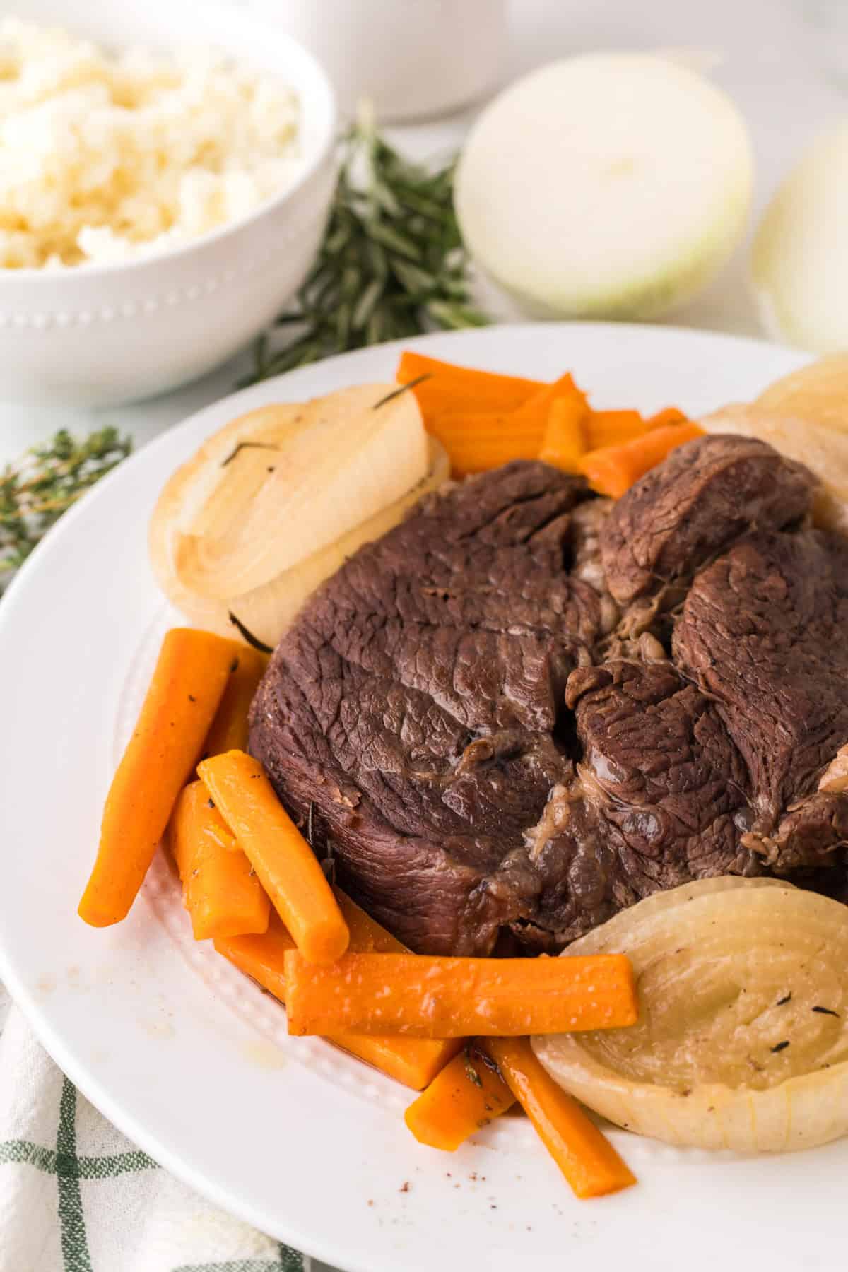 slow cooker pot roast dinner on a round white plate.