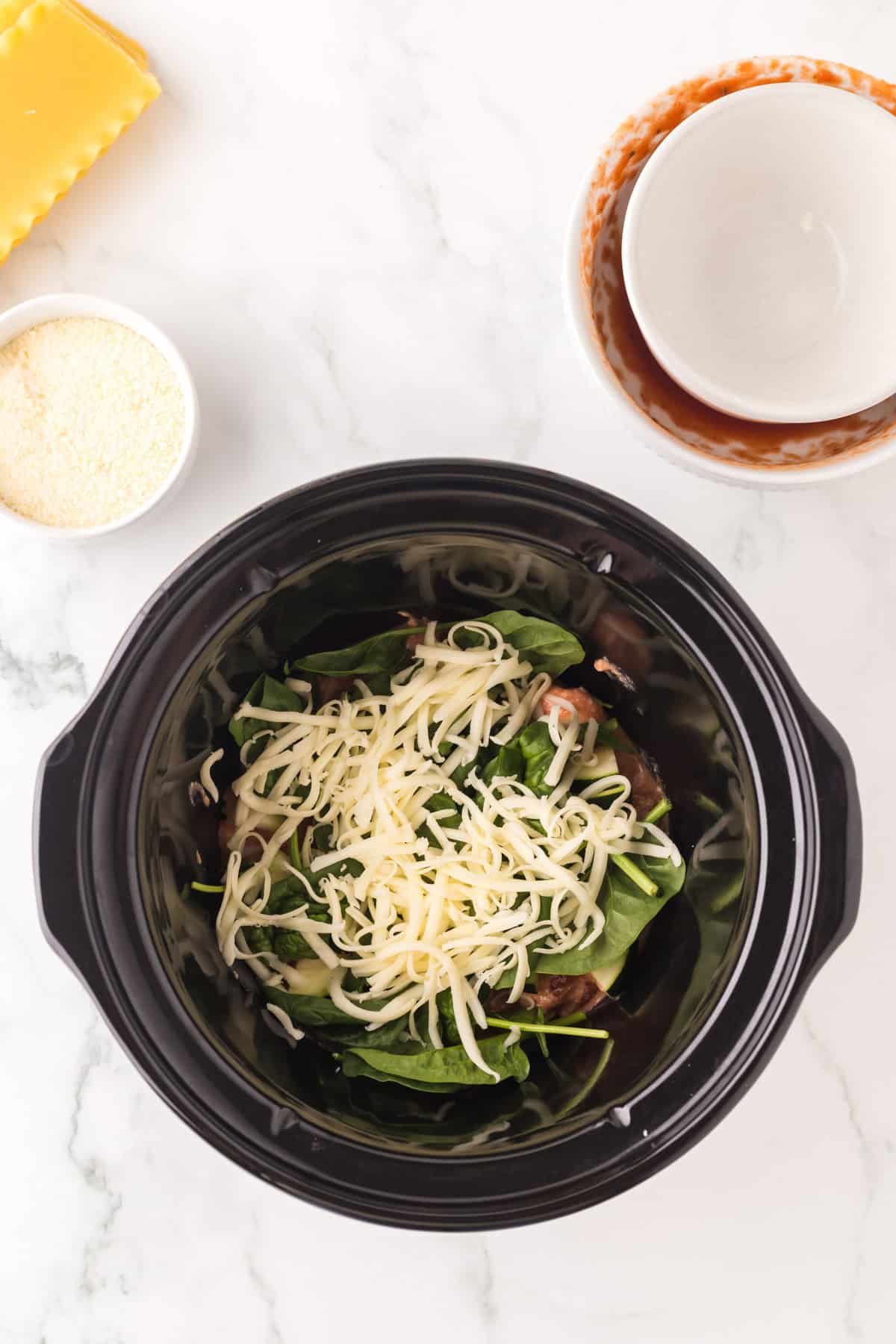 rock pot with ingredients to make slow cooker veggie lasagna sauce.