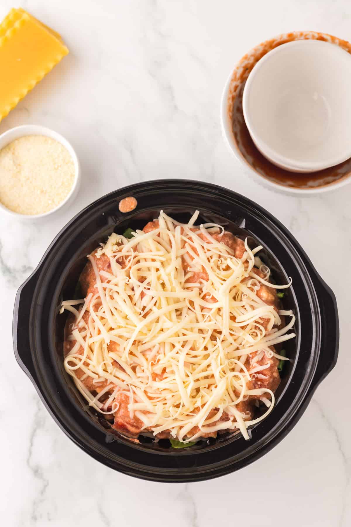 rock pot with ingredients to make slow cooker veggie lasagna sauce.