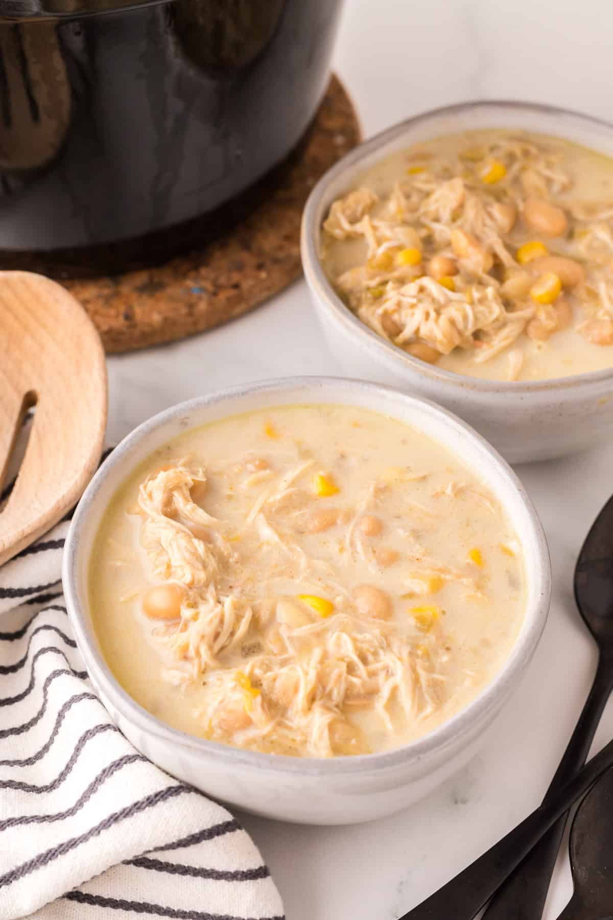 white chicken chili in white serving bowls.