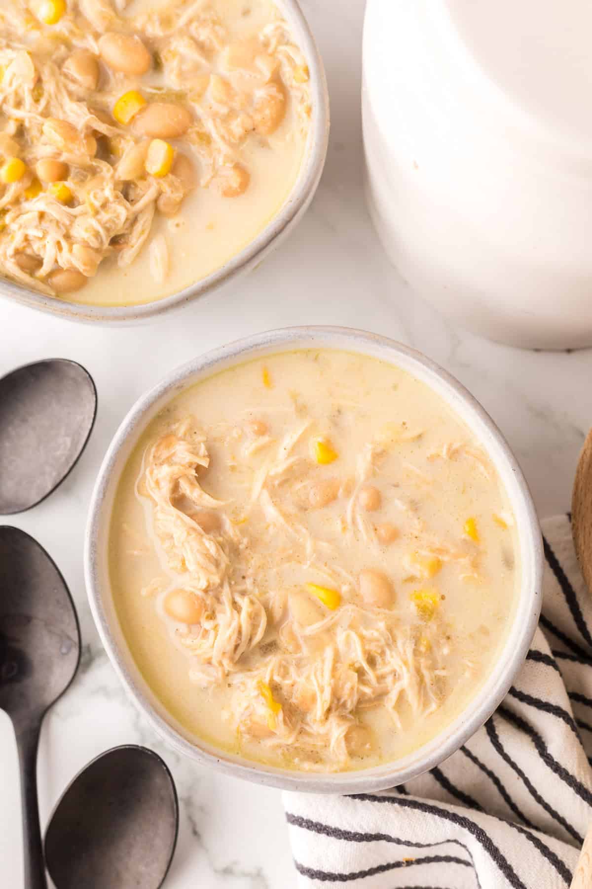 white chicken chili in white serving bowls.