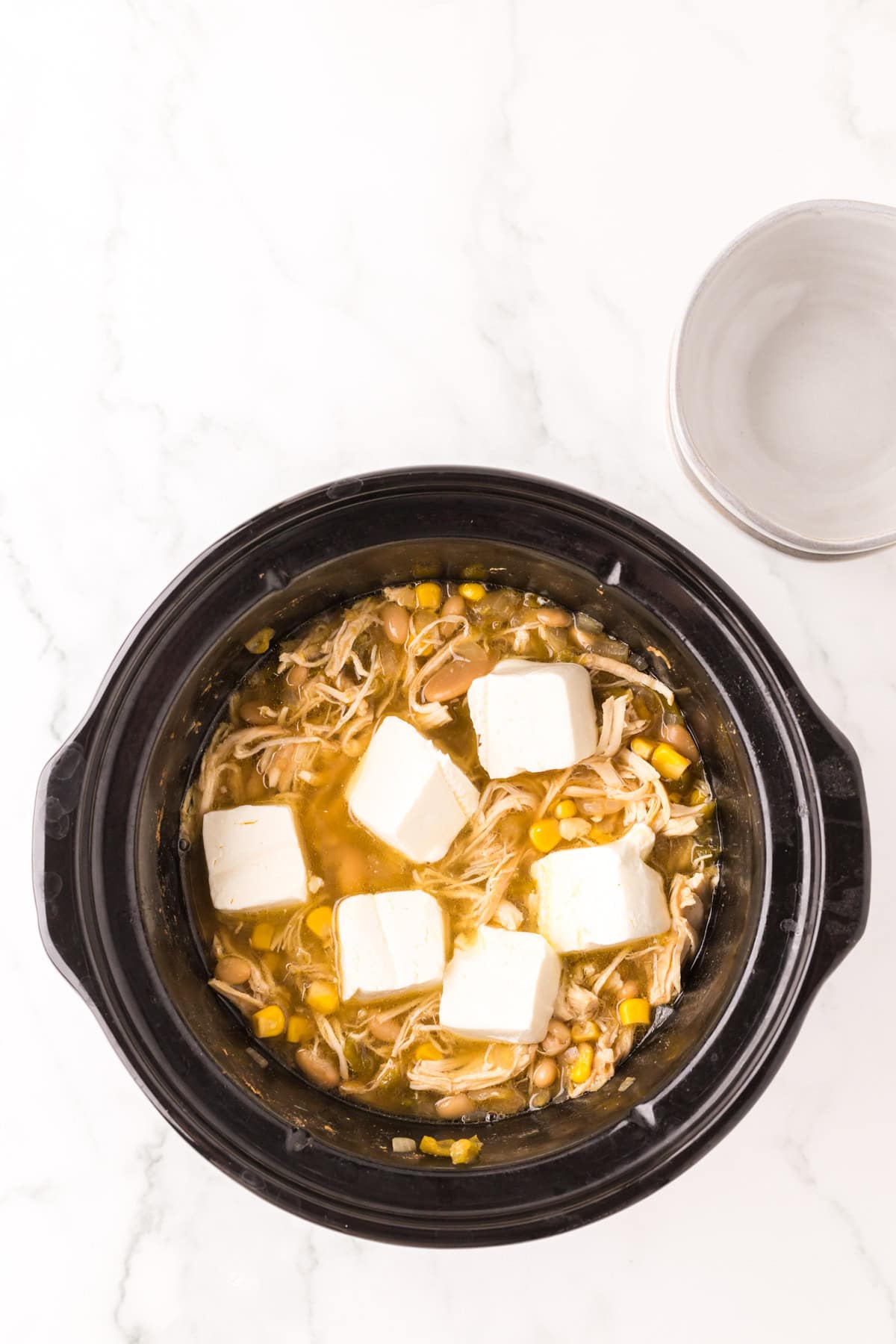 crock pot with white chicken chili recipe inside.