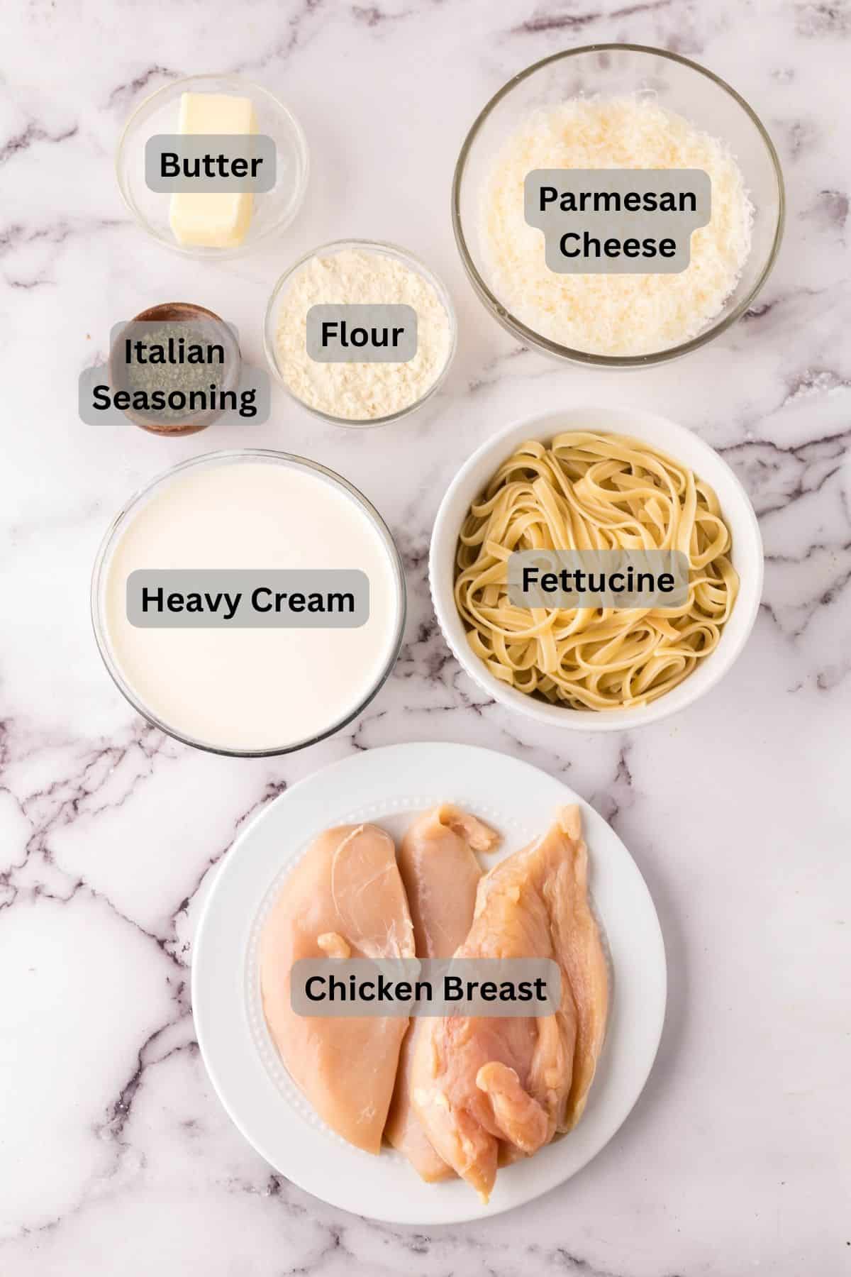 portion bowls each with digitally labeled raw ingredients to make chicken fettuccine Alfredo.