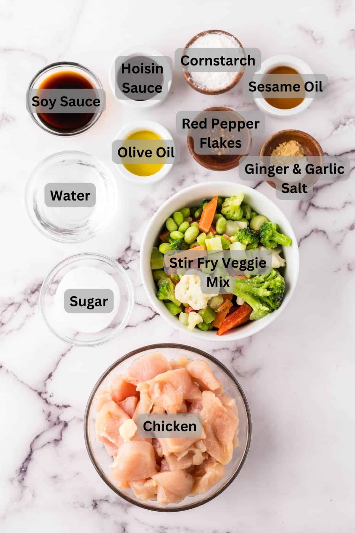 portion bowls each with digitally labeled raw ingredients to make king pow chicken recipe.