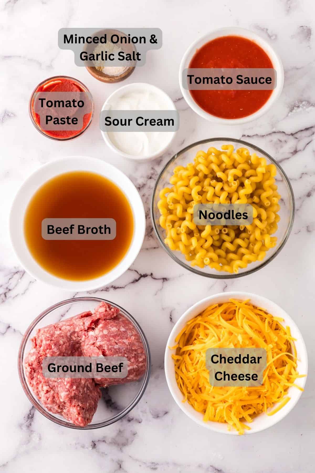 portion bowls each with digitally labeled raw ingredients to make cheeseburger casserole recipe.