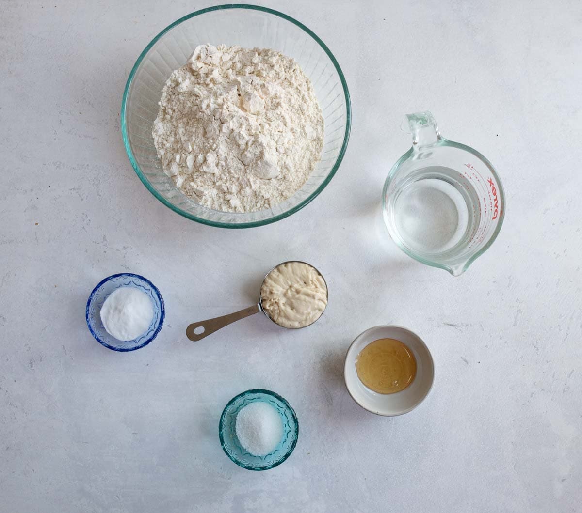 sourdough bagel ingredients on white countertop.