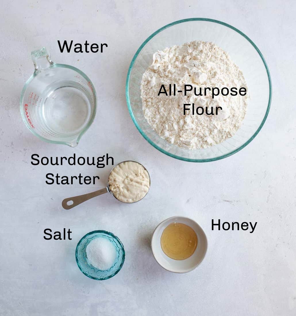 labeled ingredients for baguettes on white countertop.