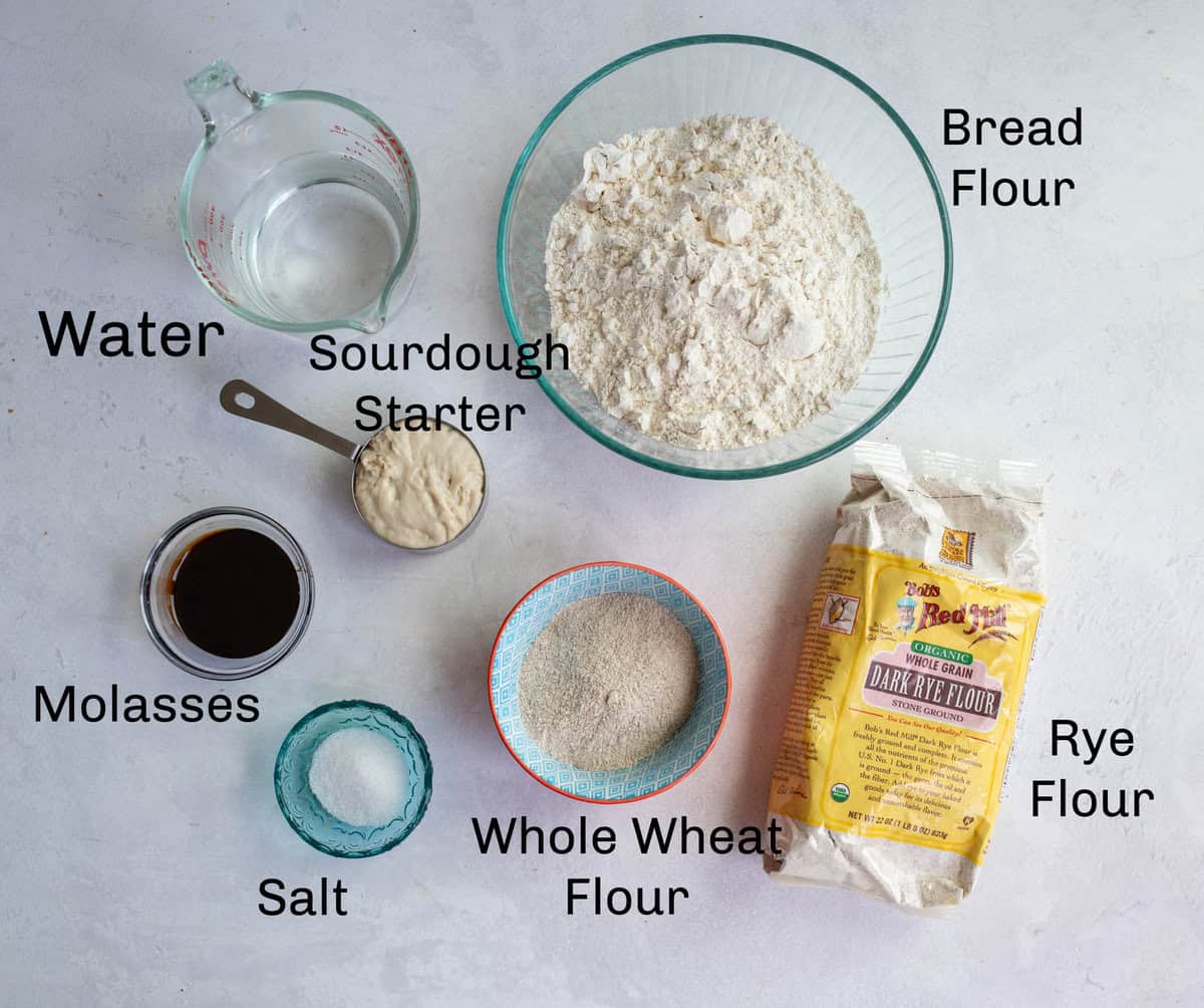 ingredients for sourdough rye bread on white countertop.