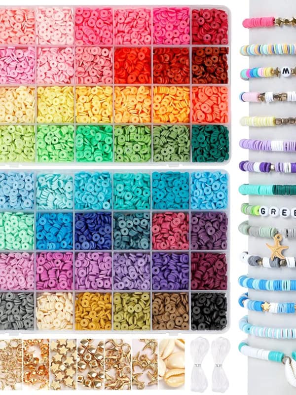 A colorful collection of small, round beads in various shades organized in bins, alongside a display of bracelets featuring the beads. There are also letter beads, gold charms, and white cords included.