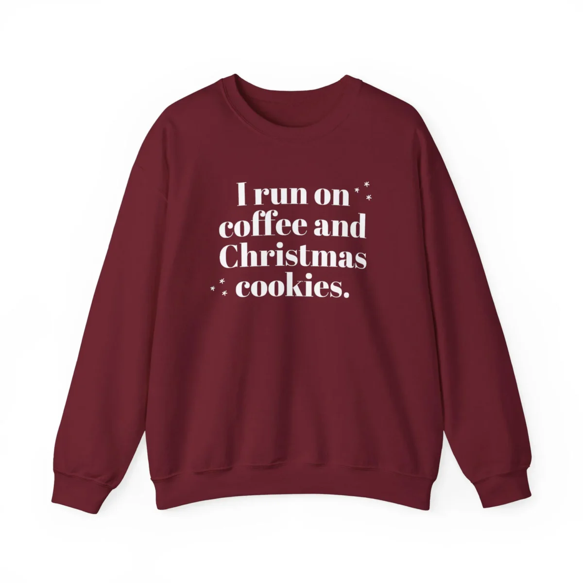 A maroon sweatshirt with the white text I run on coffee and Christmas cookies printed on the front, adorned with a few small star graphics.