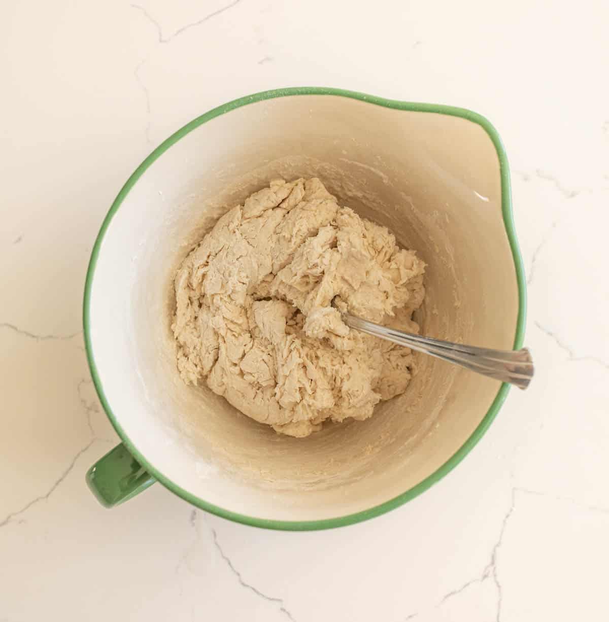 mixing together ingredients for sourdough no knead bread.