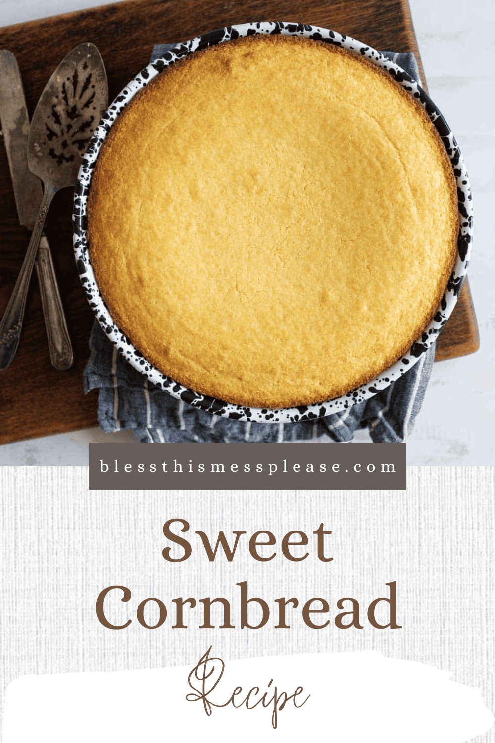 A freshly baked sweet cornbread in a round pan on a wooden board, with a striped cloth underneath. Two serving utensils are on the board. Text on the image reads blessthismessplease.com Sweet Cornbread Recipe.