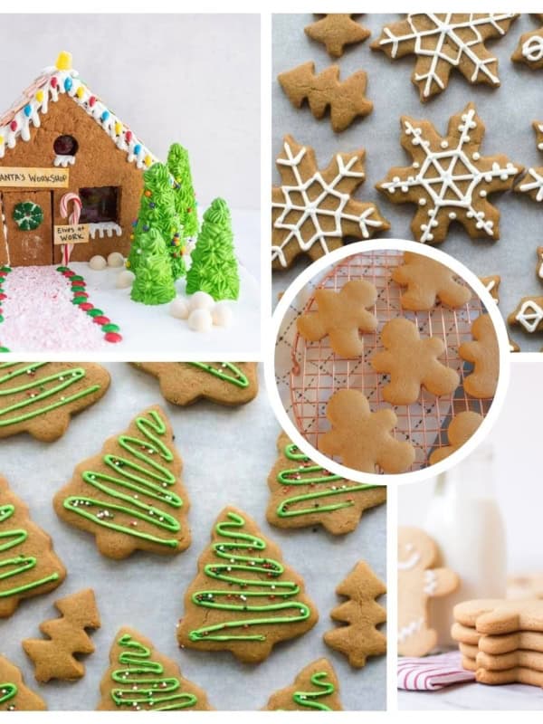 Image for gingerbread recipes with a gingerbread house decorated with candies is surrounded by various gingerbread cookies: snowflakes with icing, Christmas trees with green frosting, and plain gingerbread men. A stack of cookies and a bottle of milk are in the background.