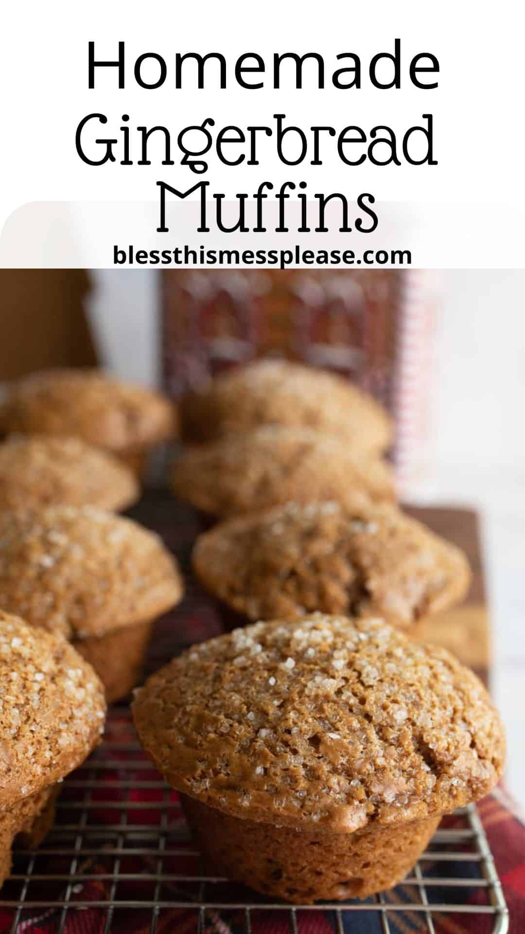 Close-up of freshly baked gingerbread muffins on a cooling rack. The muffins are topped with sugar crystals. Text at the top reads Homemade Gingerbread Muffins with a website address underneath.